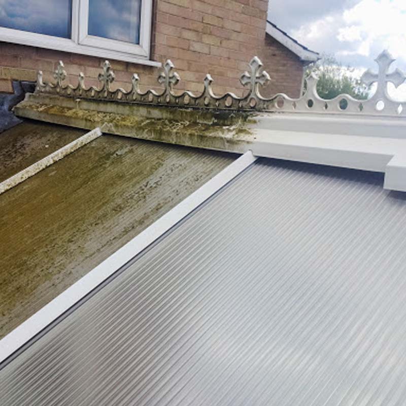 Conservatory roof panels and frames being cleaned of green algae