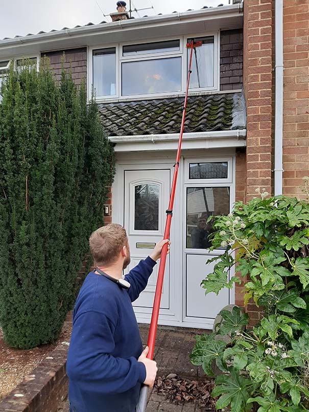 Window cleaner using a reach-and-wash pole to clean house windows